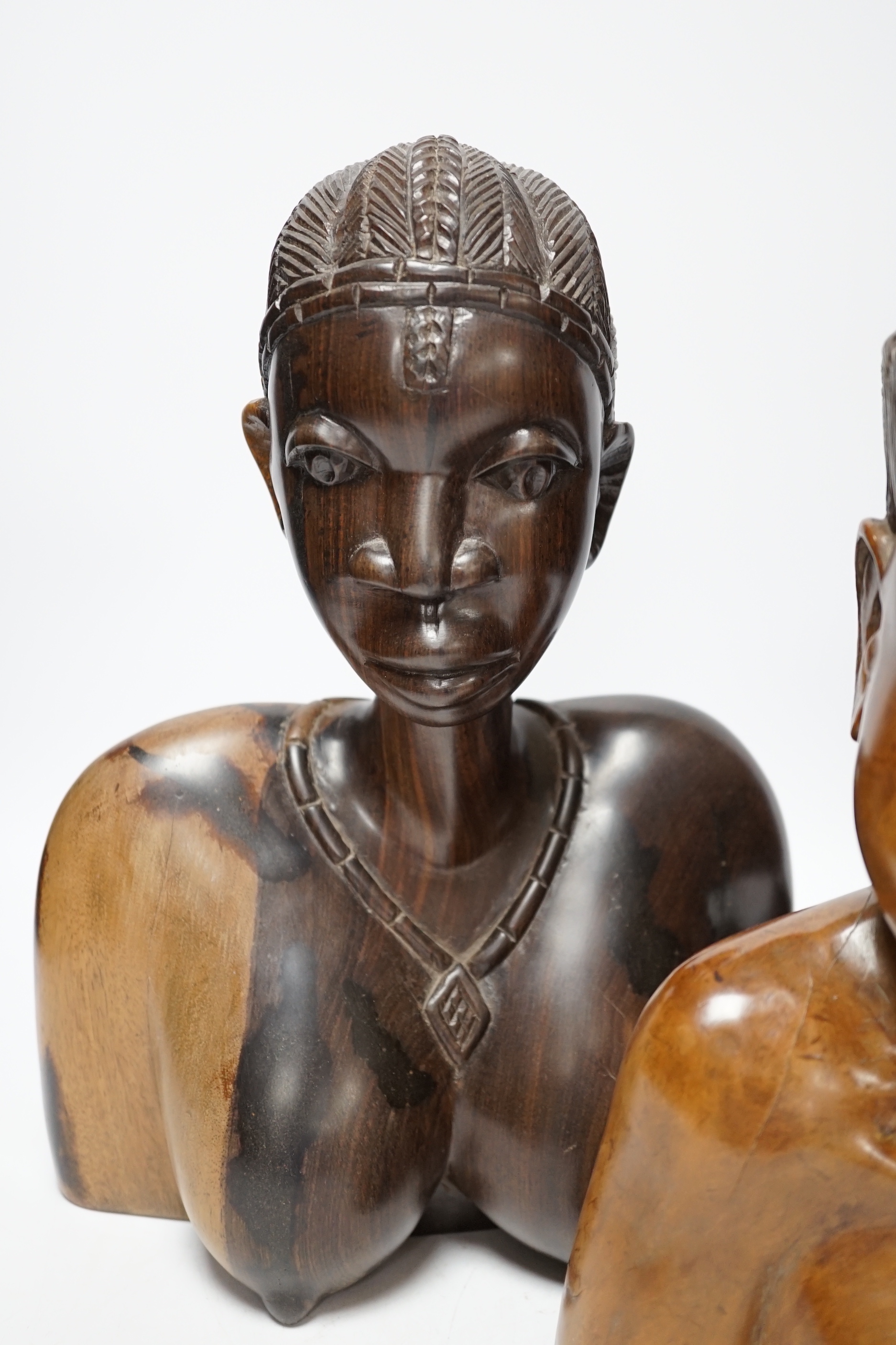A Chinese carved rootwood figure emblematic of longevity on stand and two carved African busts, Chinese root carving 36cm high